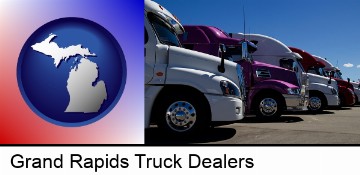 row of semi trucks at a truck dealership in Grand Rapids, MI