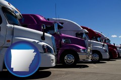 arkansas map icon and row of semi trucks at a truck dealership