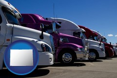 colorado map icon and row of semi trucks at a truck dealership