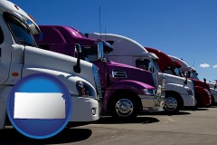 kansas map icon and row of semi trucks at a truck dealership