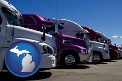 michigan map icon and row of semi trucks at a truck dealership