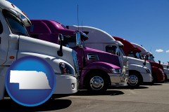 nebraska map icon and row of semi trucks at a truck dealership