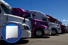 new-mexico map icon and row of semi trucks at a truck dealership