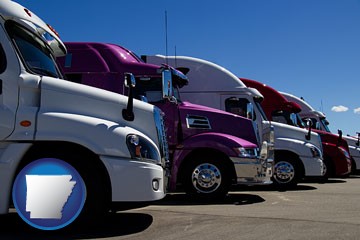 row of semi trucks at a truck dealership - with Arkansas icon