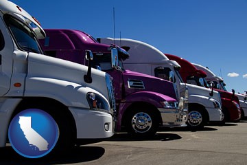 row of semi trucks at a truck dealership - with California icon