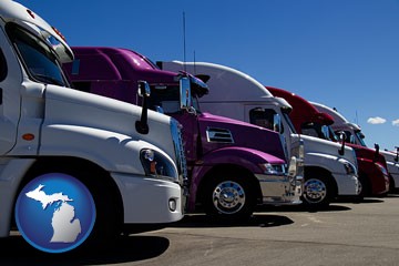 row of semi trucks at a truck dealership - with Michigan icon