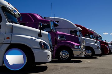 row of semi trucks at a truck dealership - with Montana icon