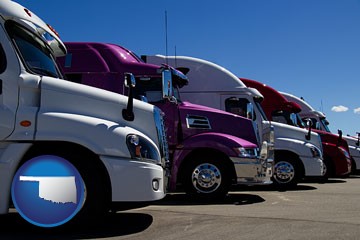 row of semi trucks at a truck dealership - with Oklahoma icon