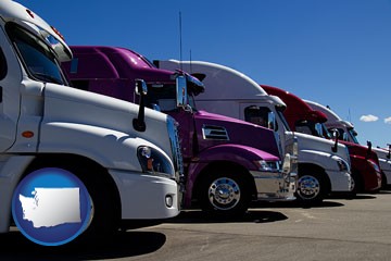 row of semi trucks at a truck dealership - with Washington icon