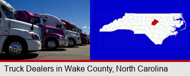 row of semi trucks at a truck dealership; Wake County highlighted in red on a map