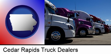 row of semi trucks at a truck dealership in Cedar Rapids, IA