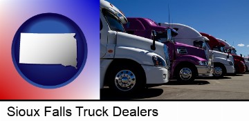 row of semi trucks at a truck dealership in Sioux Falls, SD