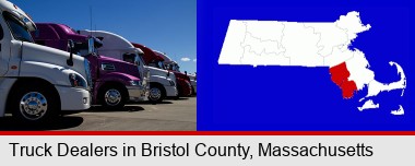 row of semi trucks at a truck dealership; Bristol County highlighted in red on a map
