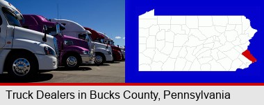 row of semi trucks at a truck dealership; Bucks County highlighted in red on a map