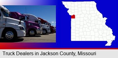 row of semi trucks at a truck dealership; Jackson County highlighted in red on a map